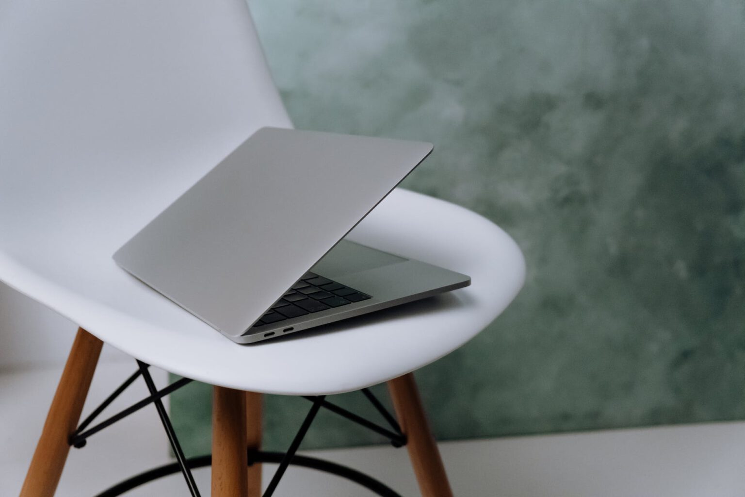 macbook pro on white chair