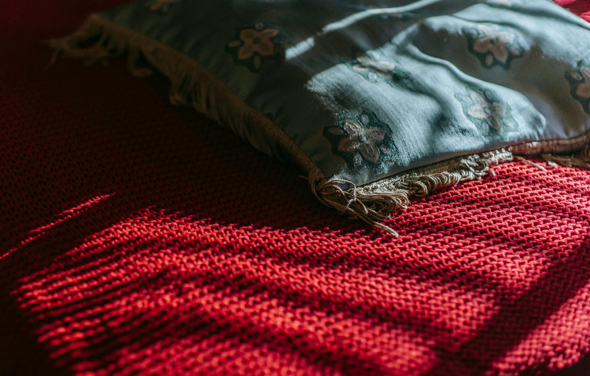 pillow placed on red blanket