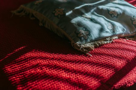 pillow placed on red blanket